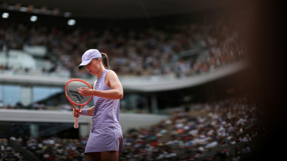 'Super tense' Swiatek falls in bid to regain French Open crown